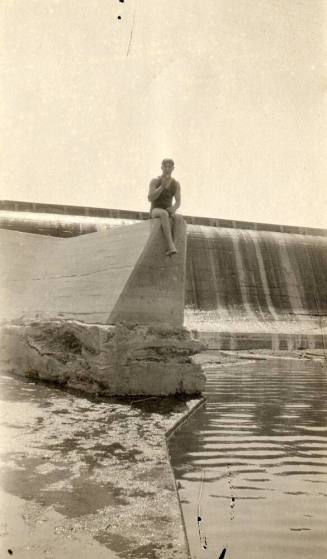A man sitting on part of Granite Reef Dam