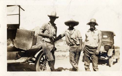 Prisoners standing by a car