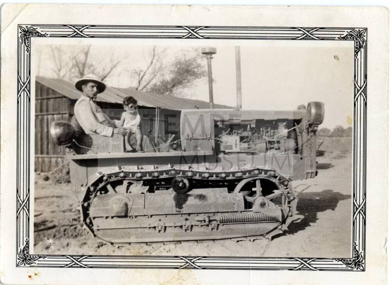 Ray Rodriguez and Ray, Jr. sit on a Catapillar machine
