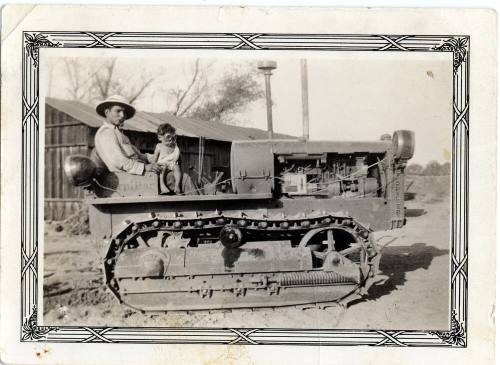 Ray Rodriguez and Ray, Jr. sit on a Catapillar machine