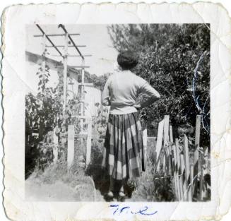 Marcie by a tree and a trellis