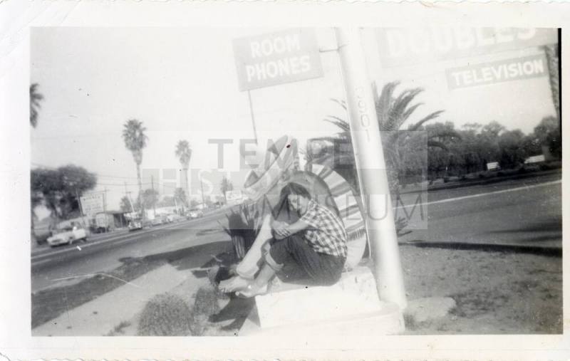 Marcie Rodriguez at Van Buren motel sign, Phoenix