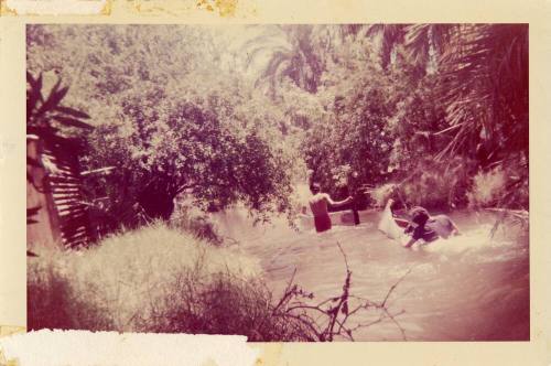 Two people and a canoe in water