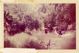 Two people and a canoe in water