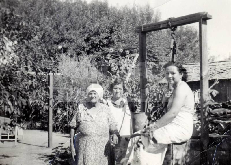 Women at a well at Rural Road near 8th Street