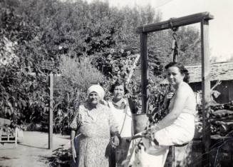 Women at a well at Rural Road near 8th Street