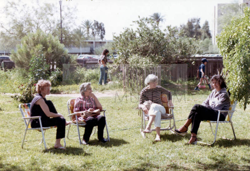Four women sit in the yard at the Elias-Rodriguez Home