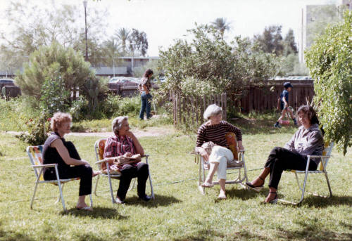 Four women sit in the yard at the Elias-Rodriguez Home
