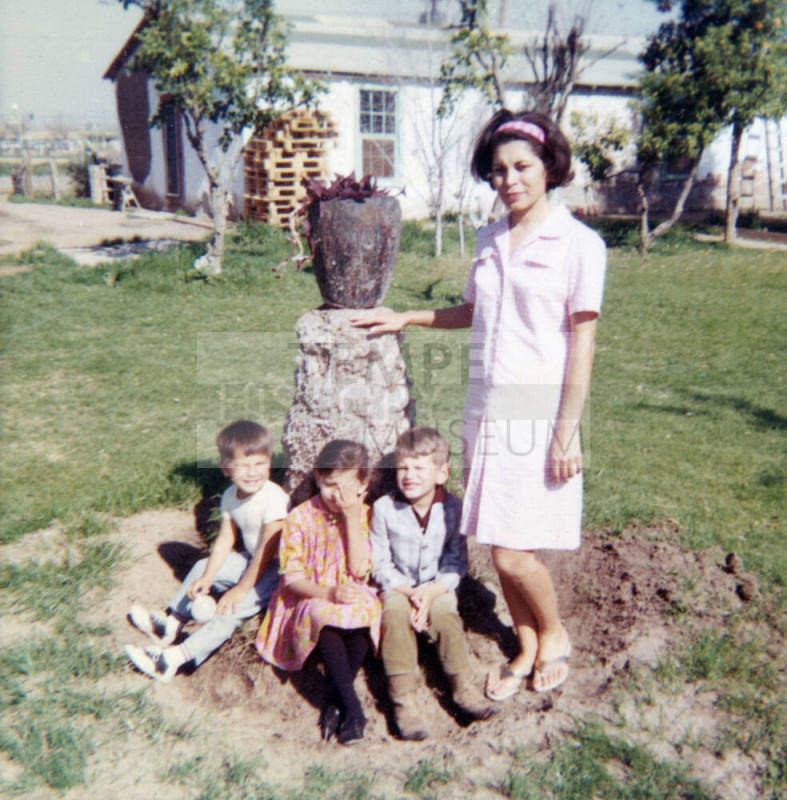 People at a Vase in a Yard