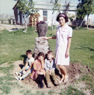 People at a Vase in a Yard