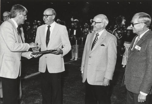 Rudy Campbell Gives Plaque to J.R. Nelson