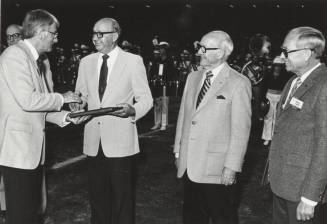 Rudy Campbell Gives Plaque to J.R. Nelson