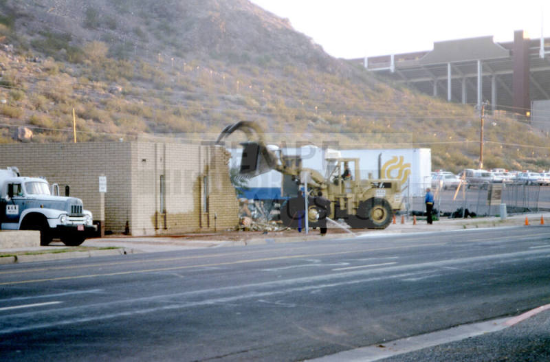 Street view of building demolition at the foot of Tempe Butte