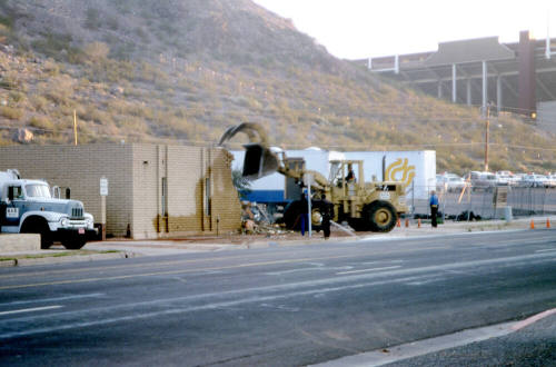 Street view of building demolition at the foot of Tempe Butte