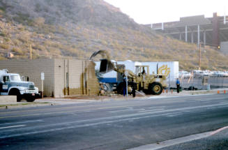 Street view of building demolition at the foot of Tempe Butte