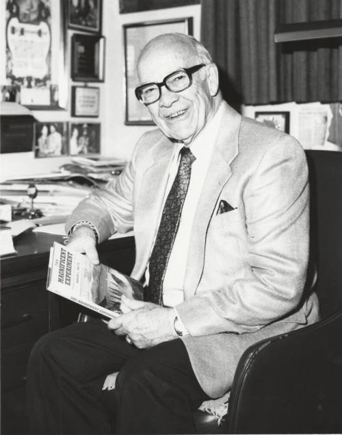 Howard Pyle Seated at a Desk with Book