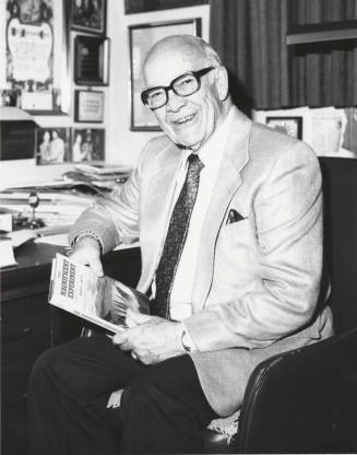 Howard Pyle Seated at a Desk with Book