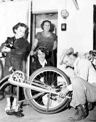 Howard Pyle Working on Bicycle, and Family