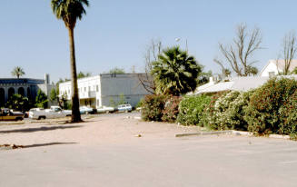 201 E. 6th Street - View of a parking lot with a building associated with the Mosque in the background