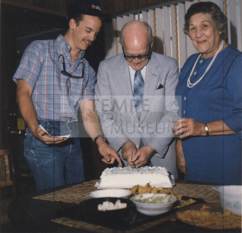 Howard Pyle, Lucile, and Grandson Cut Cake