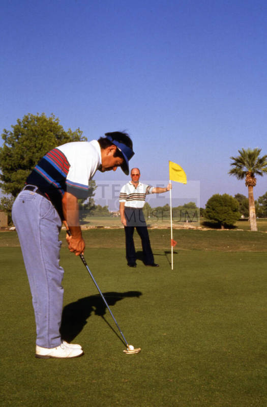 Two men playing golf near Papago Park.
