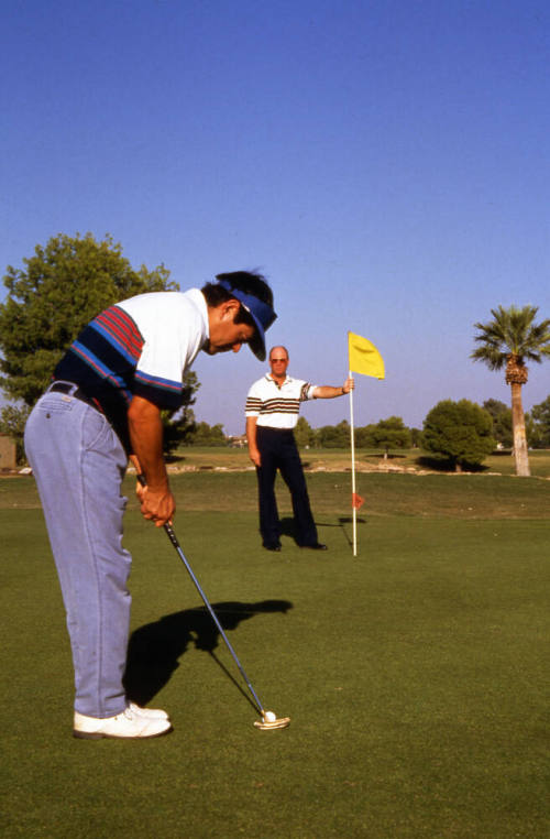 Two men playing golf near Papago Park.