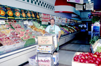 Store employee with boxes, Stabler's Market, University Dr. and Mill Ave.