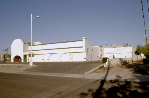 Side of shopping center, 1338 E. Apache Blvd.