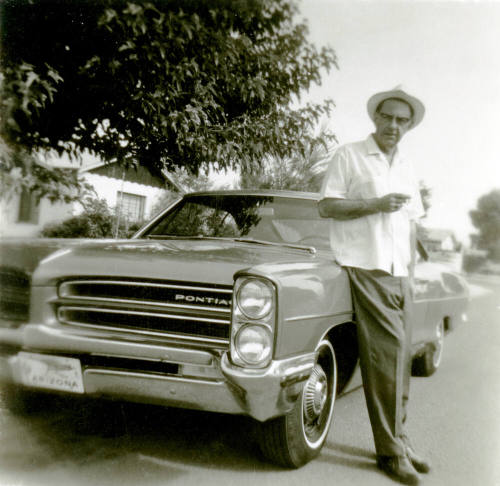 Bill Hertenstein leaning on a car