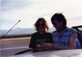 Gin Blossoms outside by a car.