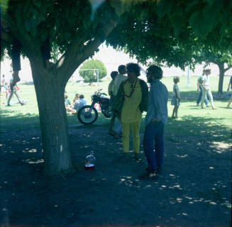 Love-in at Tempe Beach Park --2 men standing under a tree
