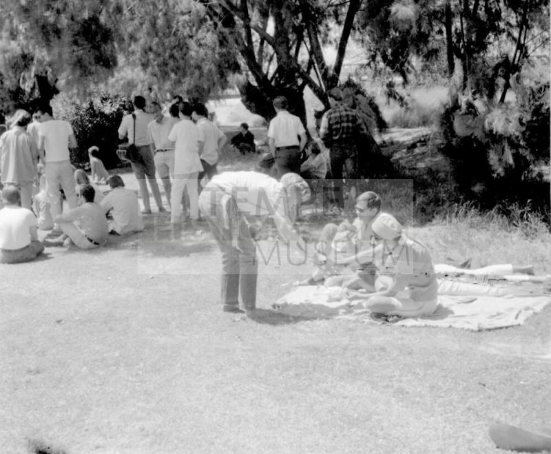 2 images of love-in, Tempe Beach Park--Couple on a blanket; seated crowd scene
