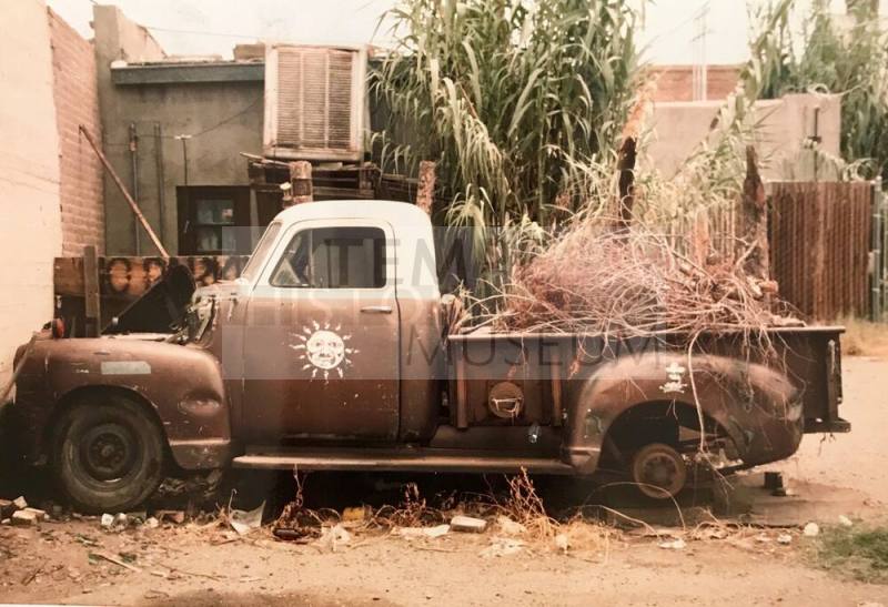 Old Pickup Truck With Sun Emblem on Door