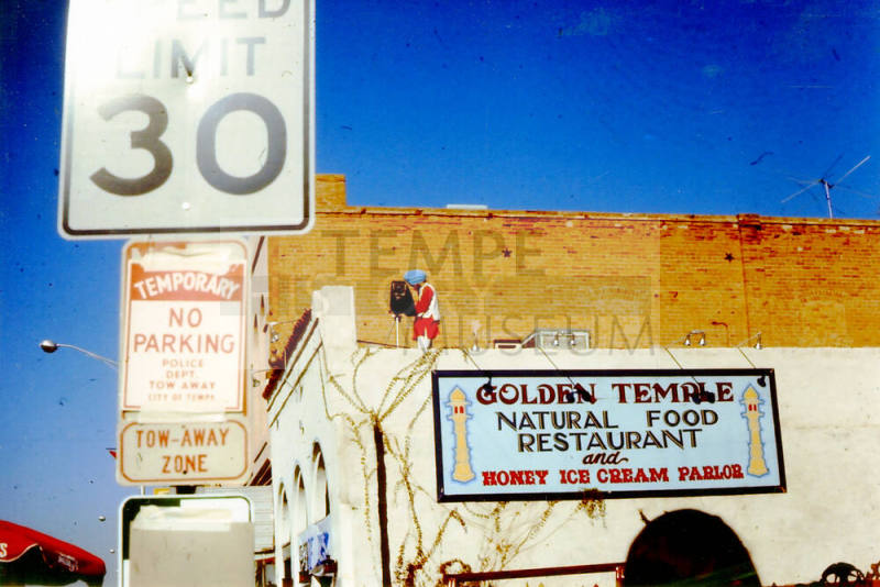 Photographer on Vienna Bakery building during 1976 Haydens Ferry Arts & Craft Fair