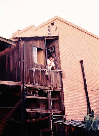Person Smoking on Balcony