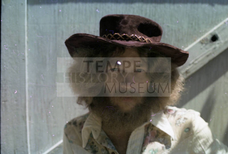 Man in Suede Hat and Floral Top