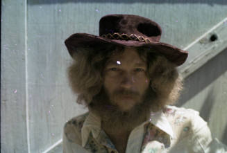 Man in Suede Hat and Floral Top
