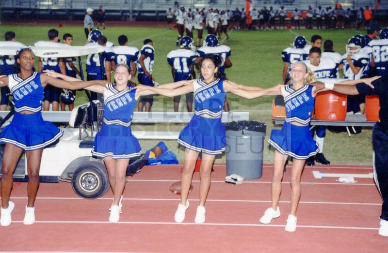 Tempe High School - 4 Cheerleaders With Arms Linked at Football Game
