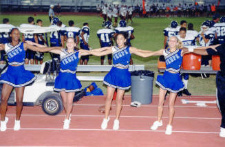 Tempe High School - 4 Cheerleaders With Arms Linked at Football Game
