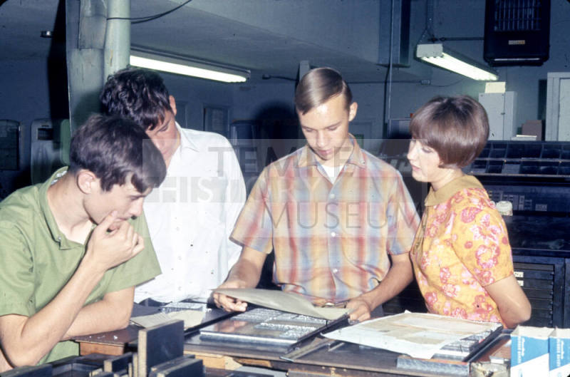 Students Reviewing Printed Pages at Tempe Daily News