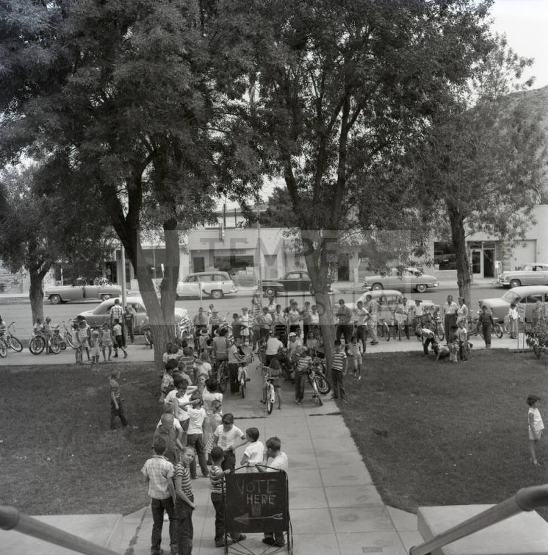 Adults and Children Standing Near a Vote Here Sign, Tempe City Hall