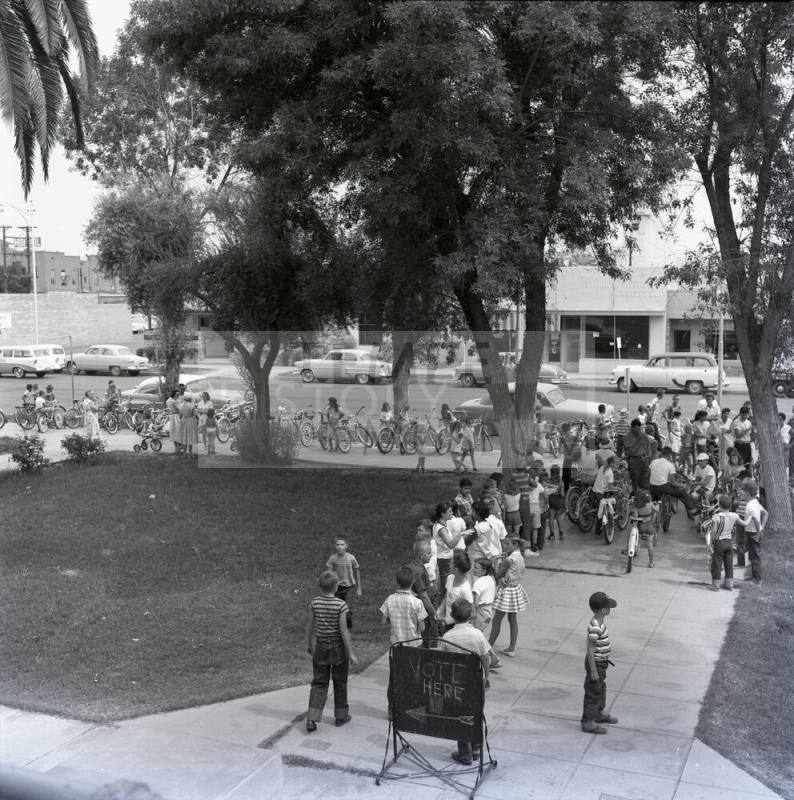 Adults and Children Standing Near a Vote Here Sign, Tempe City Hall