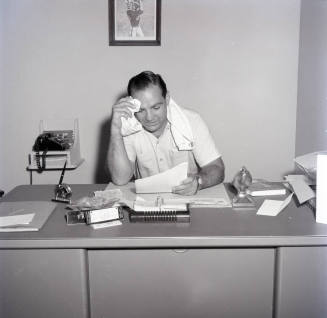 Frank Kush Seated at His Desk