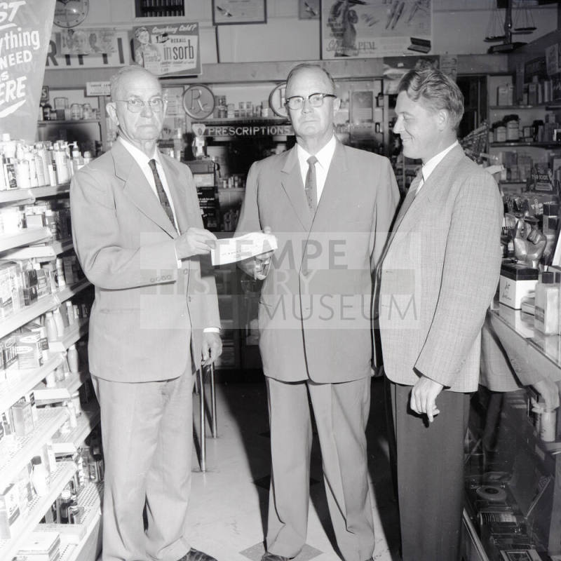 Mayor Hugh Laird Handing a Donation to 2 Men
