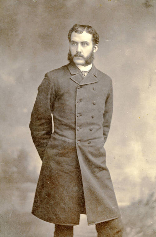 Full-length portrait of Dr. Fenn J Hart in Prince Albert suit