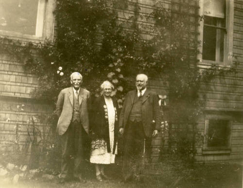 Group photo of Thomas Knight, Rosa Brown Hart and Dr. Fenn J Hart standing outside Mr. Knight's home in San Francisco.