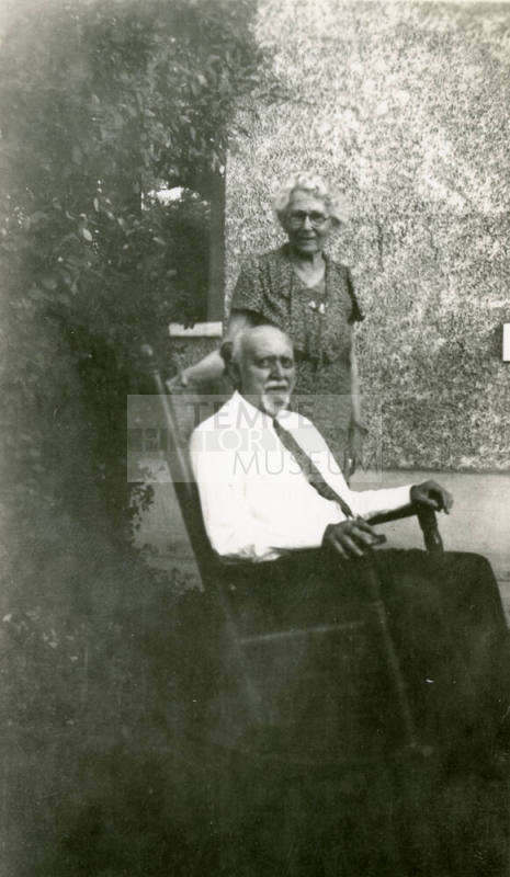 Dr. Fenn J Hart sitting in rocking chair beside his wife Rosa Brown Hart