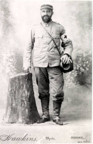 Professional portrait of Dr. Fenn J Hart standing in his Red Cross regalia in Jerome, Arizona