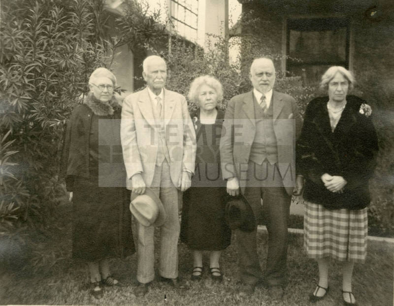 Group photo of Dr. Fenn J Hart standing outside an unknown home with his wife, Rosa Brown Hart, his brother-in-law Thomas Knight, and two unknown females