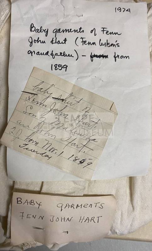 Notecards attached to the baby garments of Dr. Fenn J Hart